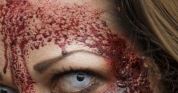 Close-up of a zombie face with intense makeup, showcasing bloody wounds and a chilling expression, perfect for horror themes.