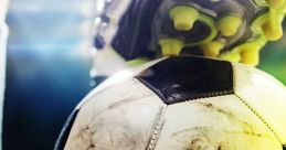 Close-up of a football with a player's boot on it, showcasing the textured surface and vibrant green grass. Perfect for soccer lovers.