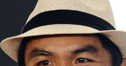 Manny Pacquiao smiling with a stylish hat, embodying charisma and charm in a vibrant setting.