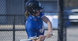 Athlete in blue RBHS Softball uniform swings bat, showcasing skill and focus on the field during a game.