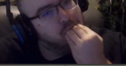 Engaged viewer in headset, contemplating while snacking; captures the essence of WingsOfRedemption Smaller Board content.