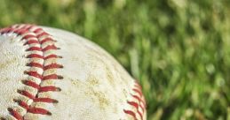 Close-up of a worn baseball resting on lush green grass, showcasing its iconic stitching and weathered surface details.