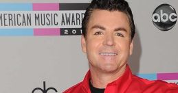 Papa John holding pizza boxes, smiling at the American Music Awards, promoting the brand with enthusiasm and energy.