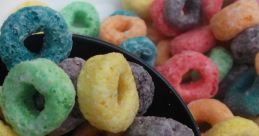 Colorful, crunchy loops in a black bowl, perfect for breakfast or snacking—vibrant flavors and fun shapes await!