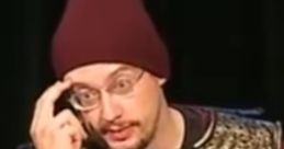 Sam Hyde performing in a gold costume and maroon beanie, showcasing his unique comedic style on stage.