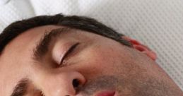 Man asleep with mouth open, illustrating the effects of loud snoring on sleep quality and nighttime disturbances.