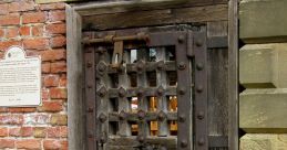 Historical prison door with intricate metalwork, showcasing rustic wood and iron details from an ancient penal facility.