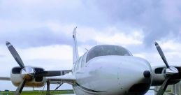 Single-engine aircraft on a rainy runway, showcasing its propellers and sleek design against cloudy skies.