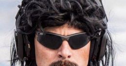 Dr Disrespect sporting iconic sunglasses and a signature mullet hairstyle, dressed in a red tactical vest for a bold look.