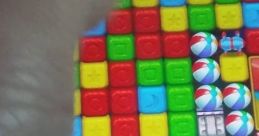 Hand moving over colorful blocks in Toy Blast; showcasing effects in a vibrant mobile gaming environment.