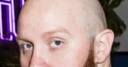 TimTheTatman with a thick red beard, bald head, and intense gaze, exuding a charismatic gaming presence.