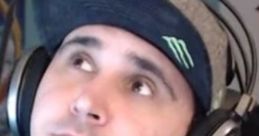 Streamer Summit1g wearing a cap and headset, looking thoughtfully while engaging with his audience in a gaming session.