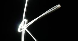 Light trail forming the letter "K" against a dark background, showcasing creativity and dynamic expression in photography.