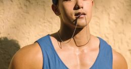 Muscular man in a blue tank top, wearing a headband, poses confidently against a textured background.