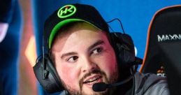 Hiko at a gaming event, wearing a headset and focused on the screen, showcasing his esports passion and dedication.