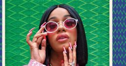 Cardi B poses confidently in a pink fur coat and stylish sunglasses against a vibrant green background, showcasing her fashion sense.