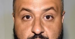 Dj Khaled sporting a stylish look with a gold chain and distinctive beard, capturing his iconic presence.