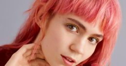 Grimes showcases her playful style with vibrant pink hair and a vintage-inspired outfit, radiating artistic flair.