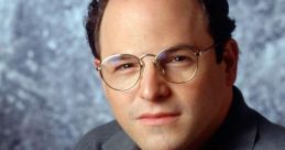 Jason Alexander posing for a portrait, wearing glasses and a casual shirt, showcasing his signature style and personality.