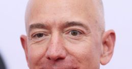 Jeff Bezos smiling in a suit and patterned tie at a public event, showcasing his influential presence in business and technology.