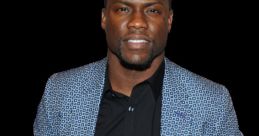 Kevin Hart smiling confidently, wearing a stylish patterned blazer over a black shirt, showcasing a vibrant personality.