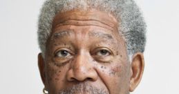 Morgan Freeman with a thoughtful expression, wearing a dark shirt, showcasing his signature gray hair and beard.