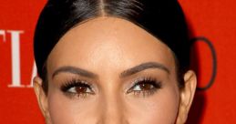 Kim Kardashian showcasing a flawless makeup look and sleek hairstyle, captured at a glamorous event with a vibrant backdrop.