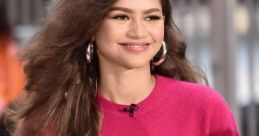 Zendaya smiles while wearing a vibrant pink outfit, showcasing her iconic style and charm at a public appearance.