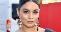 Vanessa Hudgens stunningly dressed in a black ruffled gown with statement earrings at a stylish event, showcasing her glam.