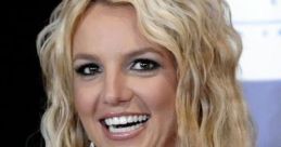 Britney Spears shines during an award ceremony, holding a trophy and beaming with joy, showcasing her iconic look.