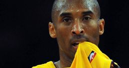 Kobe Bryant in a Lakers jersey, showing intense focus during a basketball game, showcasing his competitive spirit.