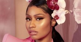 Nicki Minaj posing elegantly in a pink outfit with a floral crown, showcasing her signature glam style.