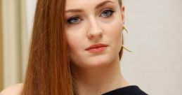 Sophie Turner with long red hair, wearing a stylish black dress, showcasing a natural yet elegant look.