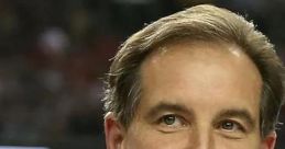 Jim Nantz smiling in a suit, known for his iconic sports commentary and hosting at major sporting events.