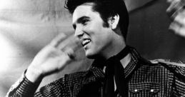 Elvis Presley performing with a guitar, showcasing his iconic style and energy in a classic black-and-white portrait.