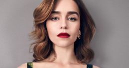 Emilia Clarke exudes elegance in a vibrant tropical print dress, showcasing her stunning features and bold red lips.