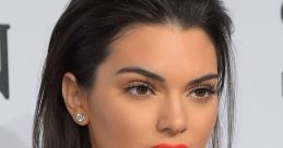 Kendall Jenner showcases a glamorous look with bold red lips and sleek hair, embodying high fashion elegance at an event.