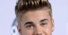 Justin Bieber smiles at an event, showcasing his stylish hairstyle and trendy attire, radiating youthful charm and confidence.