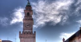 Historic Piazza with a striking clock tower, cobblestone paths, and quaint bicycle in a charming Italian town.