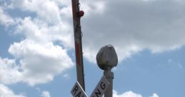 Railroad crossing sign with warning lights and arms, indicating two tracks and ensuring safety for vehicles and pedestrians.