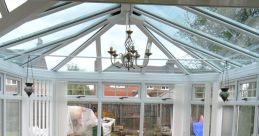 Conservatory The heavy rain on the conservatory roof created a cacophony of as water droplets pounded against the glass and