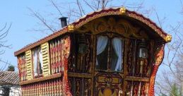 Colorful, intricately designed vintage wagon with ornate patterns, set against a vibrant green grass background.