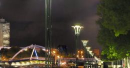 Night view of the Yarra River promenade in Melbourne, lined with street lamps and illuminated pathways.