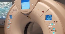 Toshiba Aquilion scanner in a medical setting, ready for patient imaging with illuminated control panels.