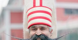 Traditional Turkish man in colorful attire with distinctive hat and elaborate mustache, showcasing Turkish culture and heritage.