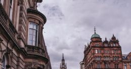 Busy Glasgow street scene with historic architecture, police presence, and iconic red taxi on a cloudy day.