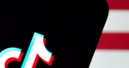 TikTok logo displayed on a smartphone against a red and white background, symbolizing social media trends in America.