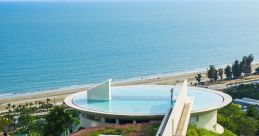 Stunning view of a modern library with surrounding greenery and a rooftop pool overlooking the ocean at Water Hatch Library.