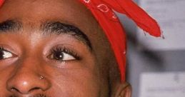 Tupac Shakur smiling with a red bandana, showcasing his iconic style and charisma in hip-hop culture.