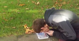 Person interacting with a book outdoors, showcasing unique reading habits related to the concept of a "Snorting Library.